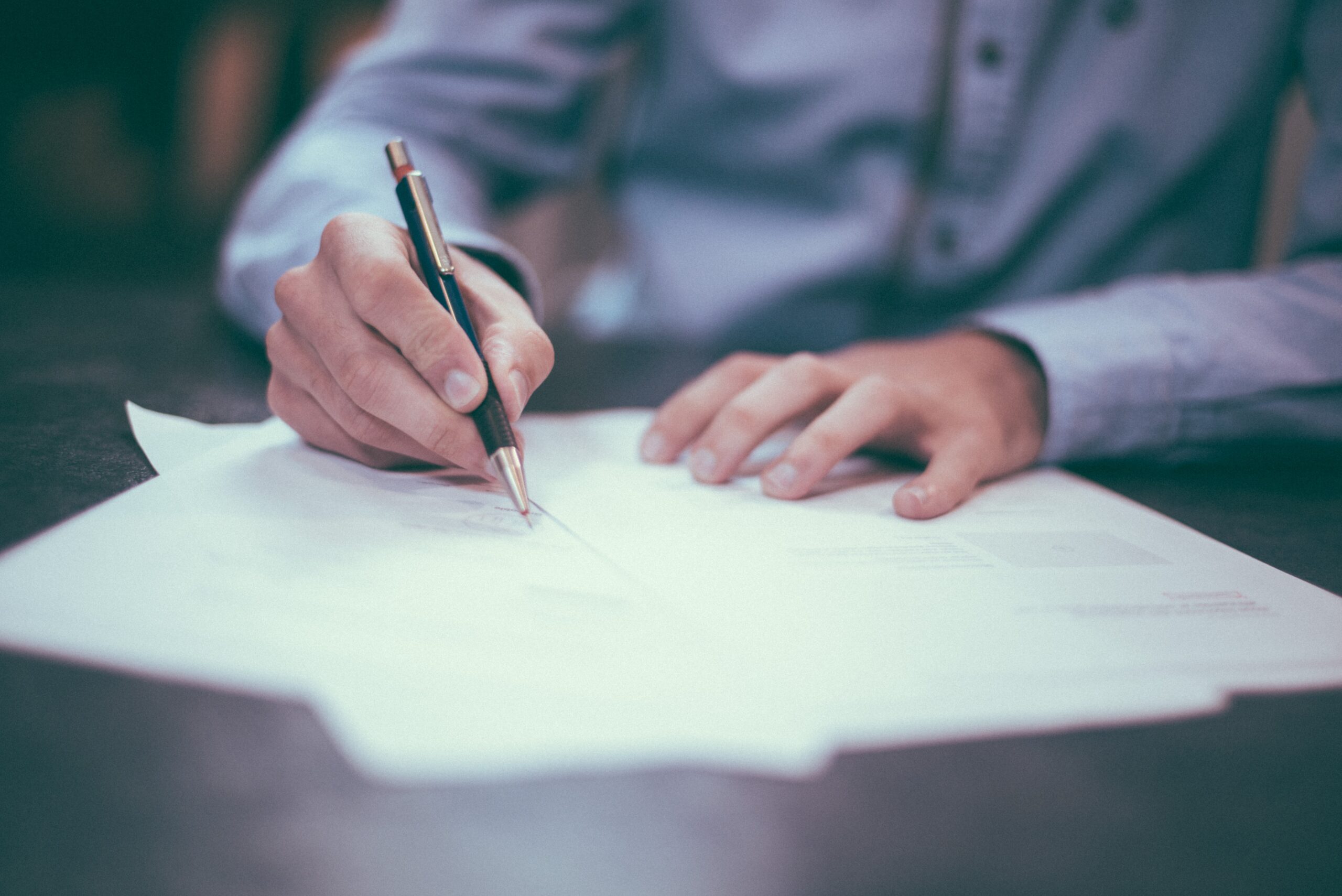 A photo of a man signing documents